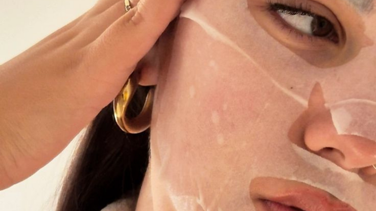 Woman resting with a hydrating sheet mask on her face